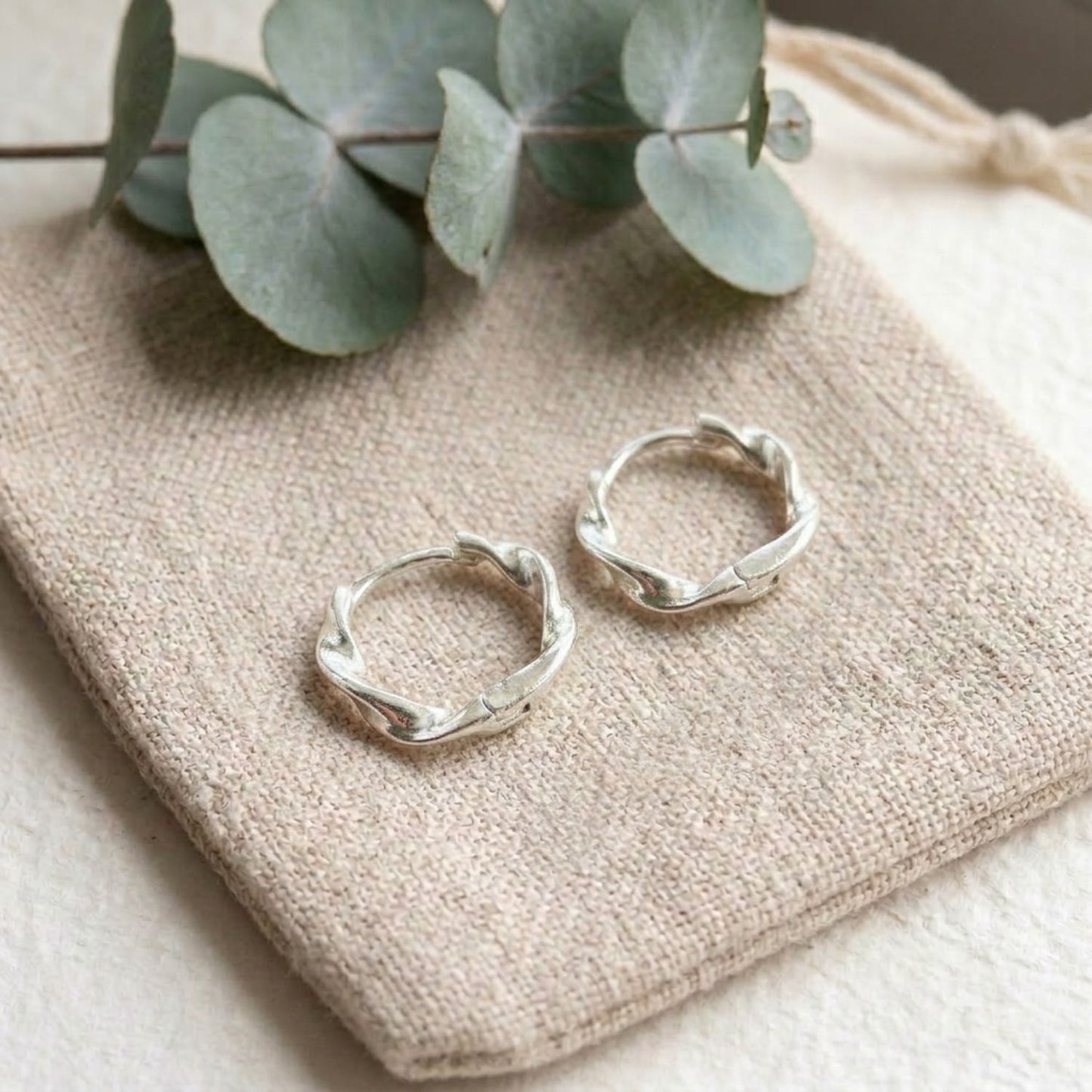 Twisted huggie hoop earrings — sterling silver, 16mm