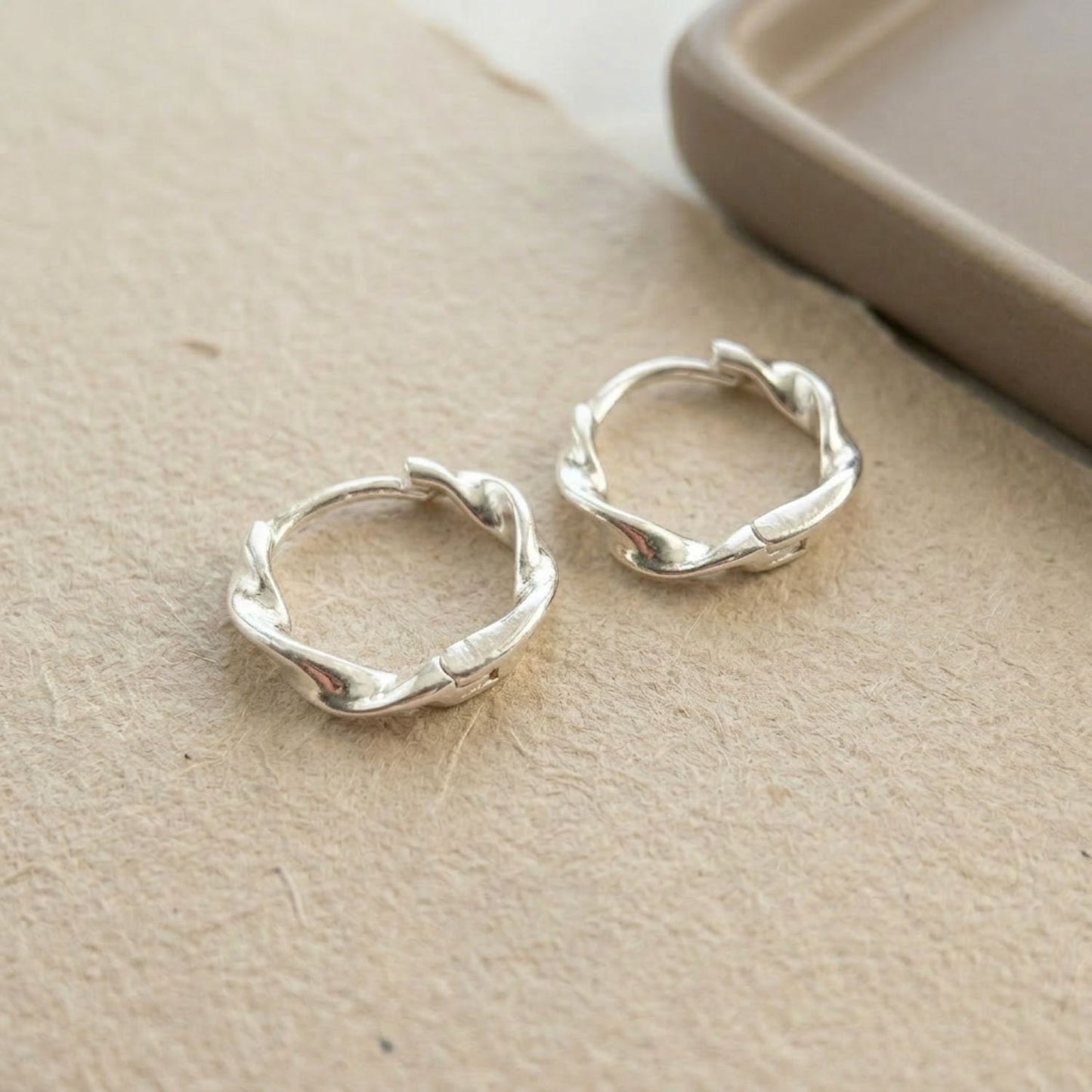 Twisted huggie hoop earrings — sterling silver, 16mm